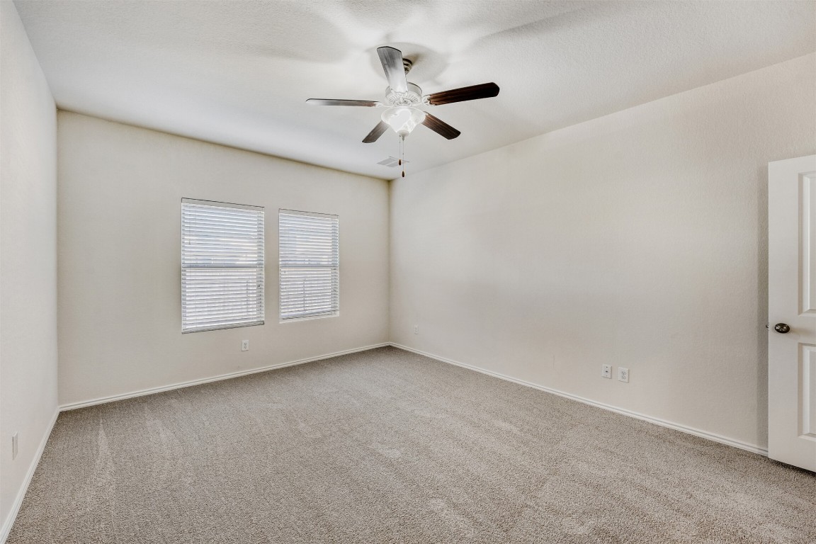 433 Druse Lane Jarrell, TX 76537 - Photo 13 of 28 Empty room featuring light carpet and ceiling fan