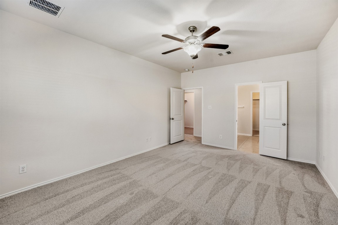 433 Druse Lane Jarrell, TX 76537 - Photo 14 of 28 Unfurnished bedroom with a ceiling fan and light carpet