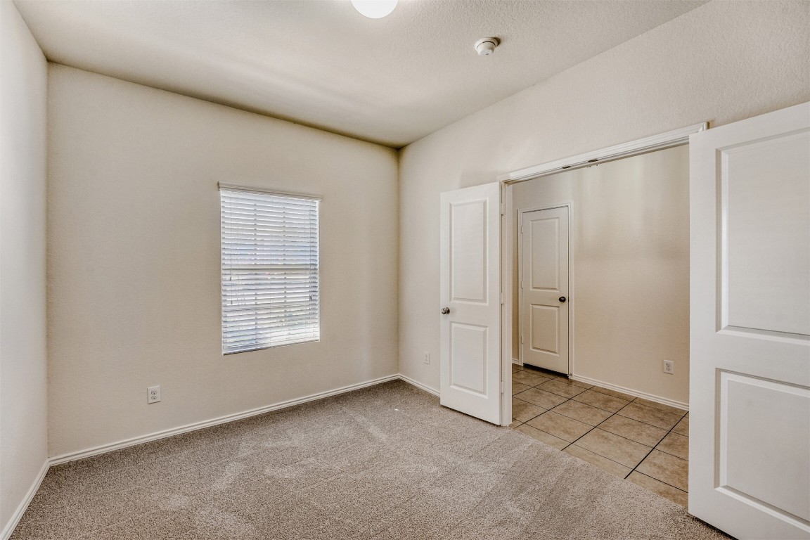 433 Druse Lane Jarrell, TX 76537 - Photo 19 of 28 Unfurnished bedroom with light carpet and light tile patterned flooring