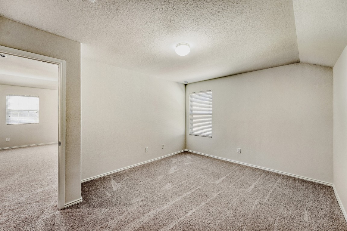 433 Druse Lane Jarrell, TX 76537 - Photo 20 of 28 Carpeted spare room with a textured ceiling and baseboards