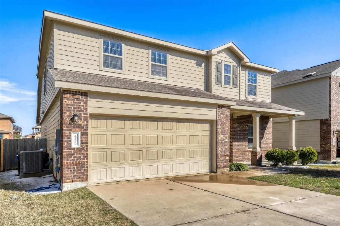 433 Druse Lane Jarrell, TX 76537 - Photo 2 of 28 View of front facade featuring an attached garage, brick siding, and concrete driveway
