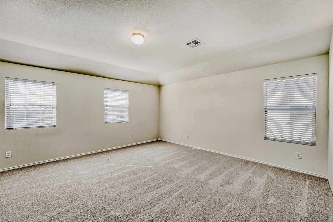 433 Druse Lane Jarrell, TX 76537 - Photo 21 of 28 Empty room with light colored carpet and a textured ceiling