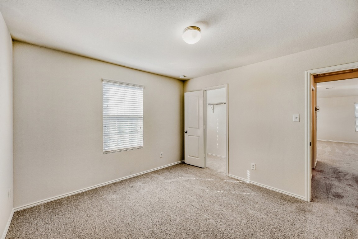 433 Druse Lane Jarrell, TX 76537 - Photo 23 of 28 Unfurnished bedroom featuring carpet floors and baseboards