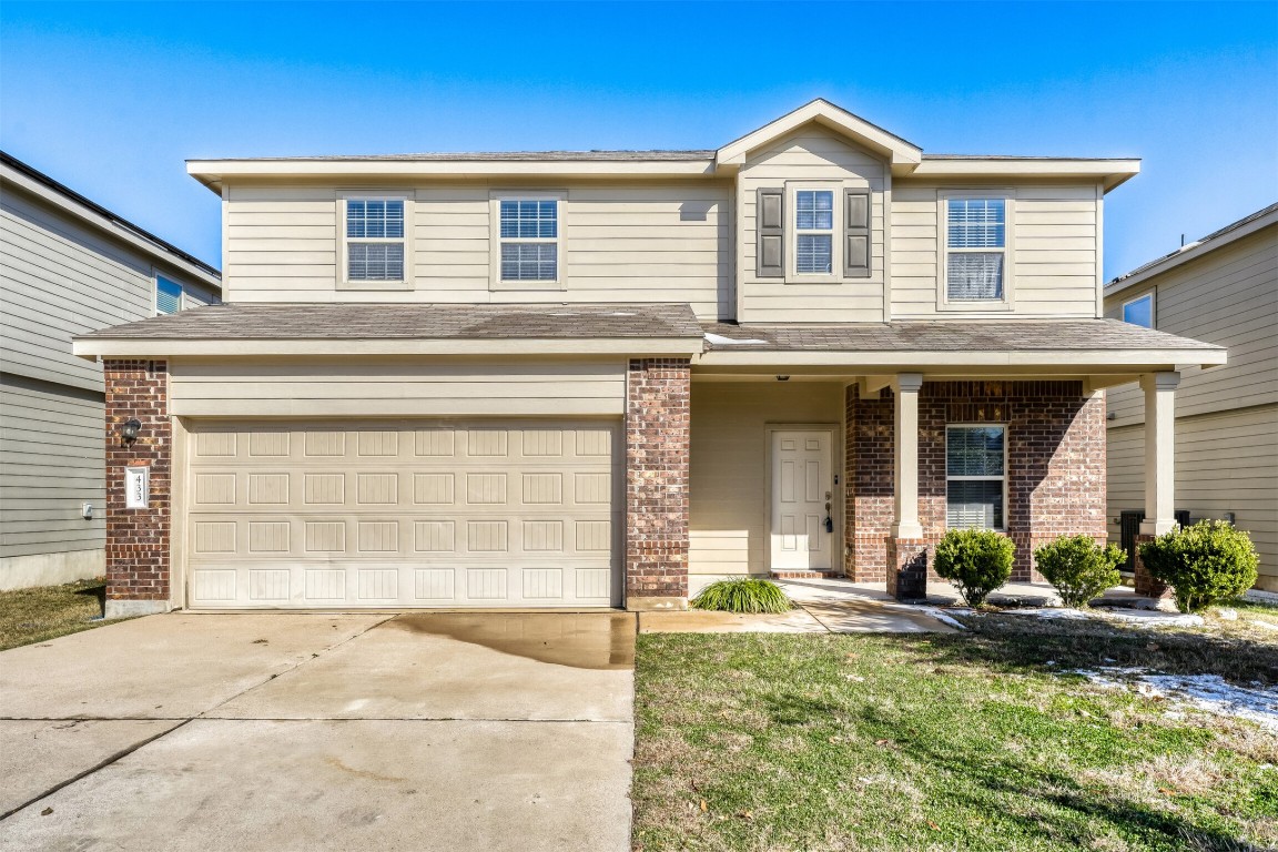 433 Druse Lane Jarrell, TX 76537 - Photo 3 of 28 Traditional-style home with a garage, brick siding, covered porch, concrete driveway, and a shingled roof