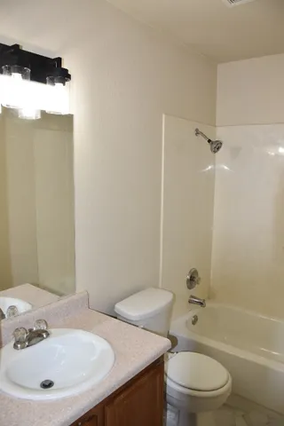 a bathroom with a white toilet and a shower