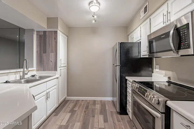 a kitchen with a refrigerator stove and microwave