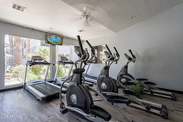 a car parked in front of a building with potted plants