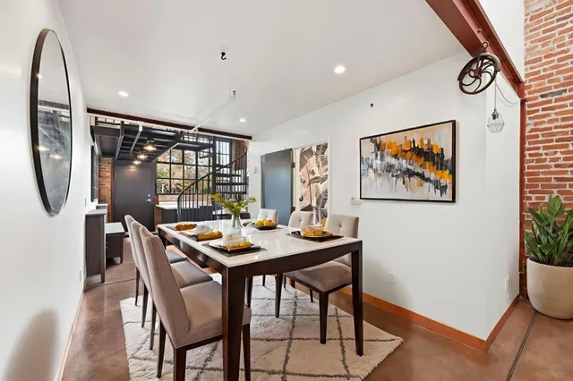 a dining room with furniture window and wooden floor