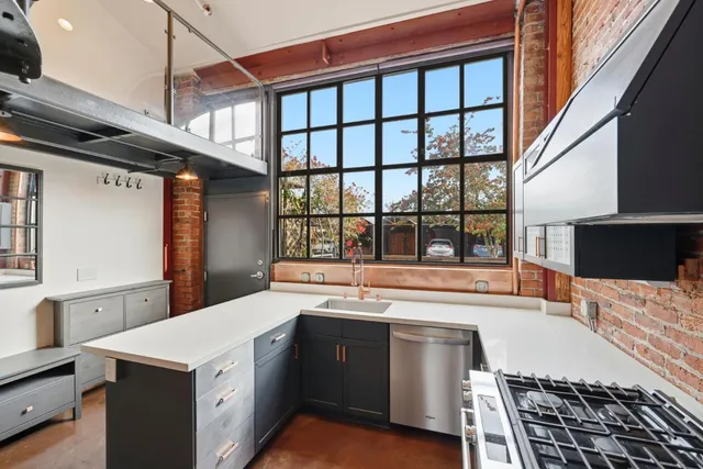 a large white kitchen with a large window