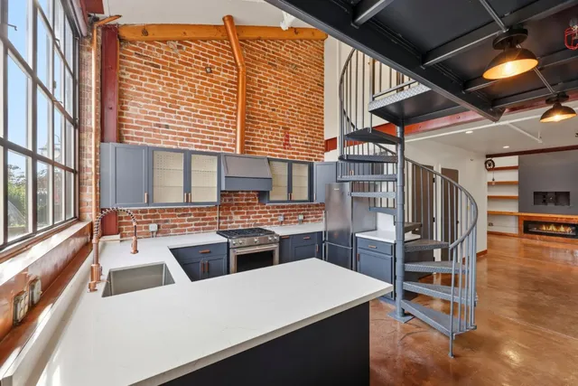 a kitchen with a stove a refrigerator and a stove top oven