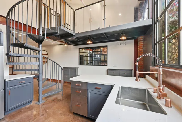 a view of a kitchen with furniture and staircase
