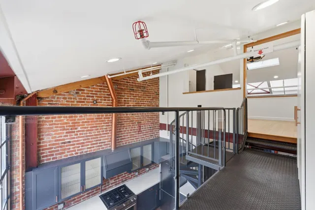 a view of a hallway with furniture and window