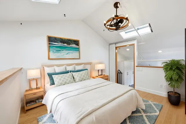 a bedroom with a bed and a chandelier