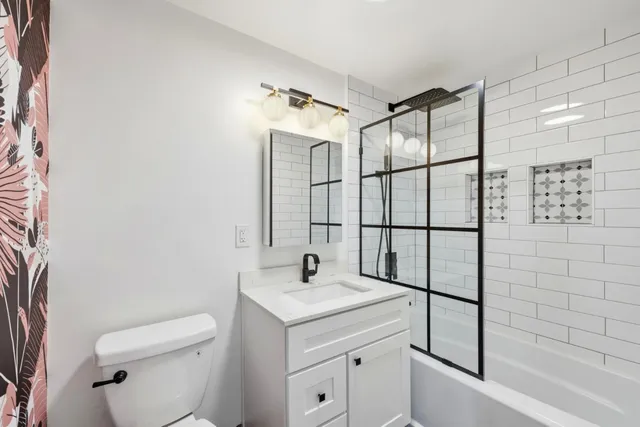 a bathroom with a sink toilet and shower