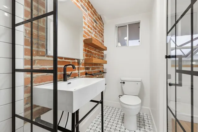 a bathroom with a toilet sink and mirror