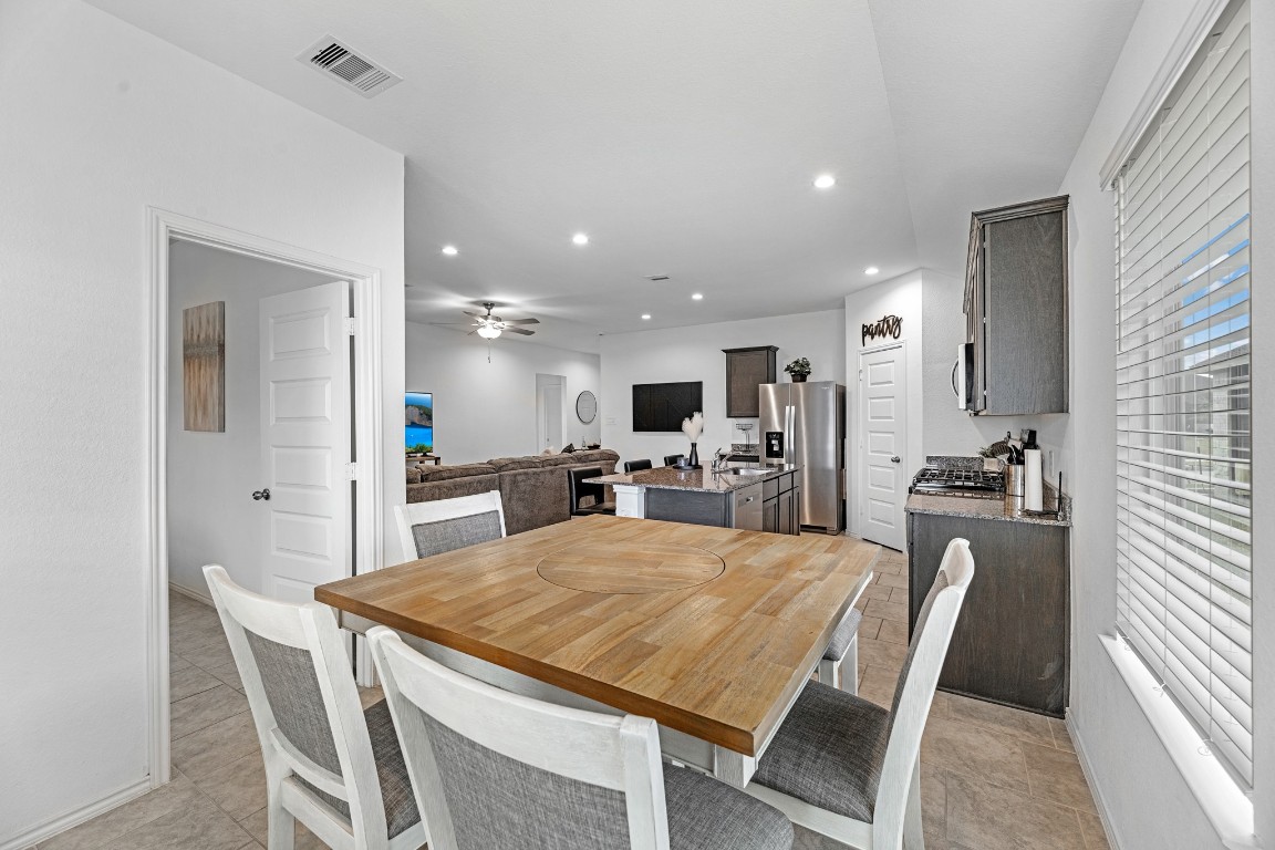 7534 Cynomys Court Rosharon, TX 77583 - Photo 15 of 35 a large kitchen with kitchen island granite countertop a table and chairs