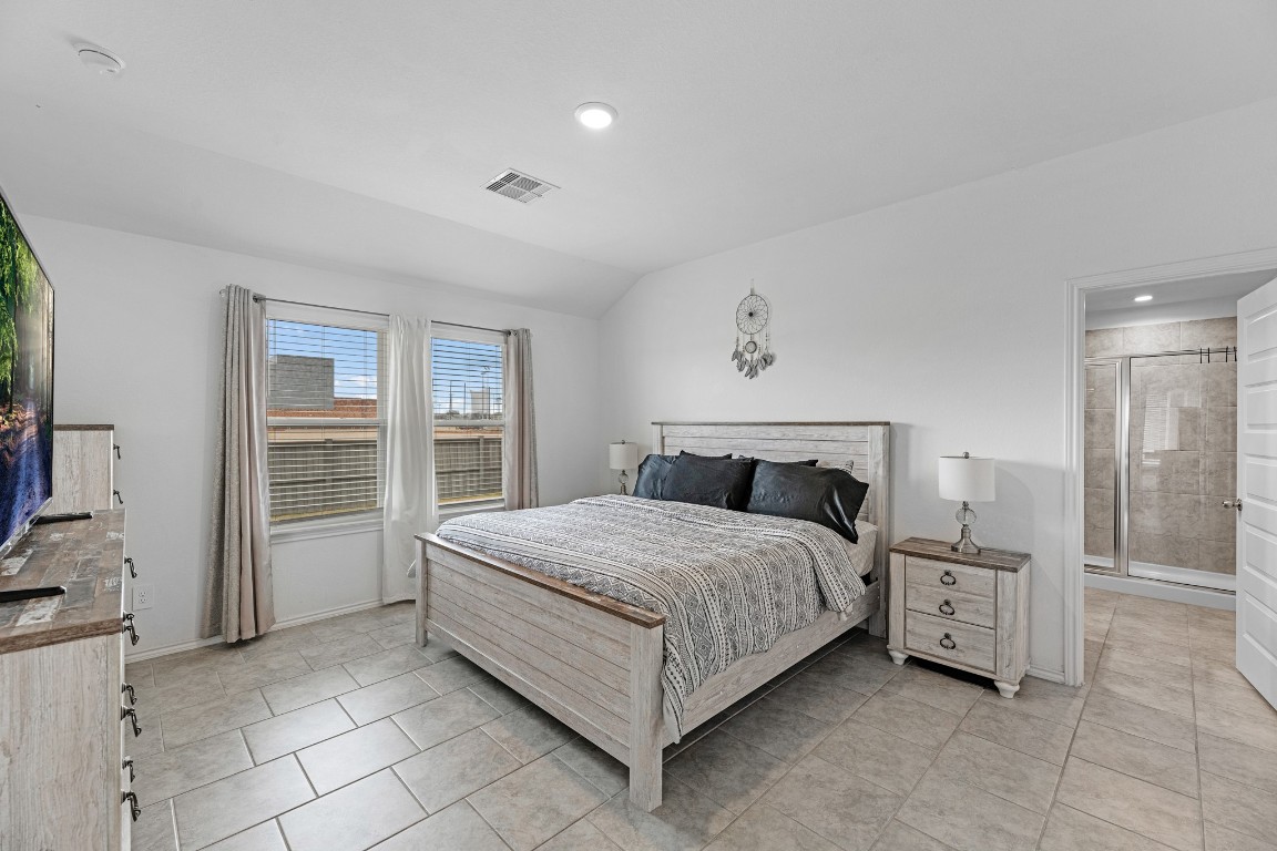 7534 Cynomys Court Rosharon, TX 77583 - Photo 16 of 35 a spacious bedroom with a bed and a refrigerator