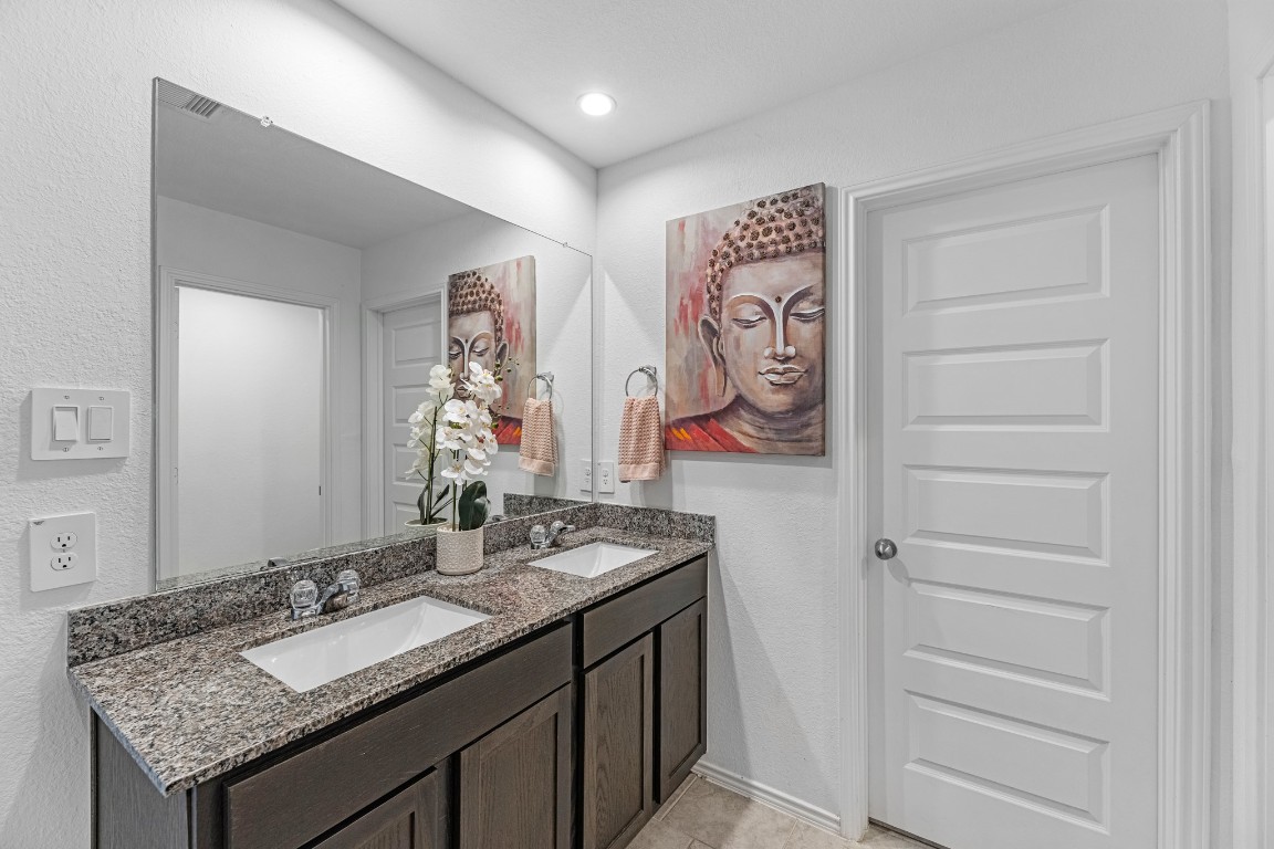 7534 Cynomys Court Rosharon, TX 77583 - Photo 19 of 35 a bathroom with a granite countertop sink and a mirror