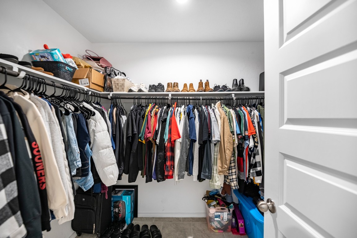 7534 Cynomys Court Rosharon, TX 77583 - Photo 21 of 35 a view of walk in closet with clothes and shoes