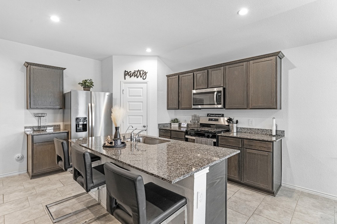7534 Cynomys Court Rosharon, TX 77583 - Photo 6 of 35 a kitchen with a sink stove and refrigerator