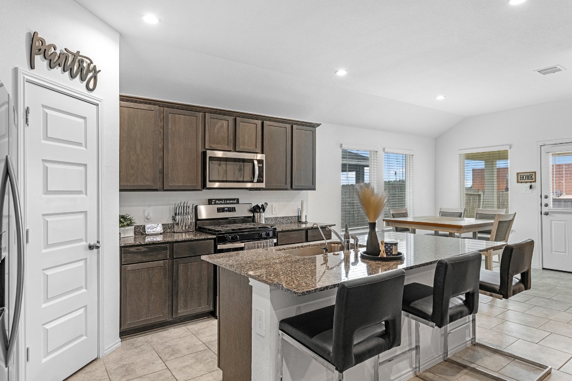 7534 Cynomys Court Rosharon, TX 77583 - Photo 7 of 35 a kitchen with a sink stainless steel appliances and cabinets
