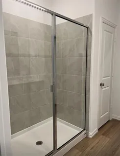 a bathroom with a shower and a bathtub