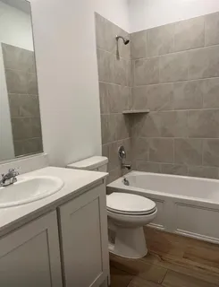 a bathroom with a sink toilet and shower