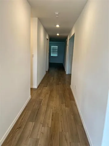 a view of gallery with wooden floor