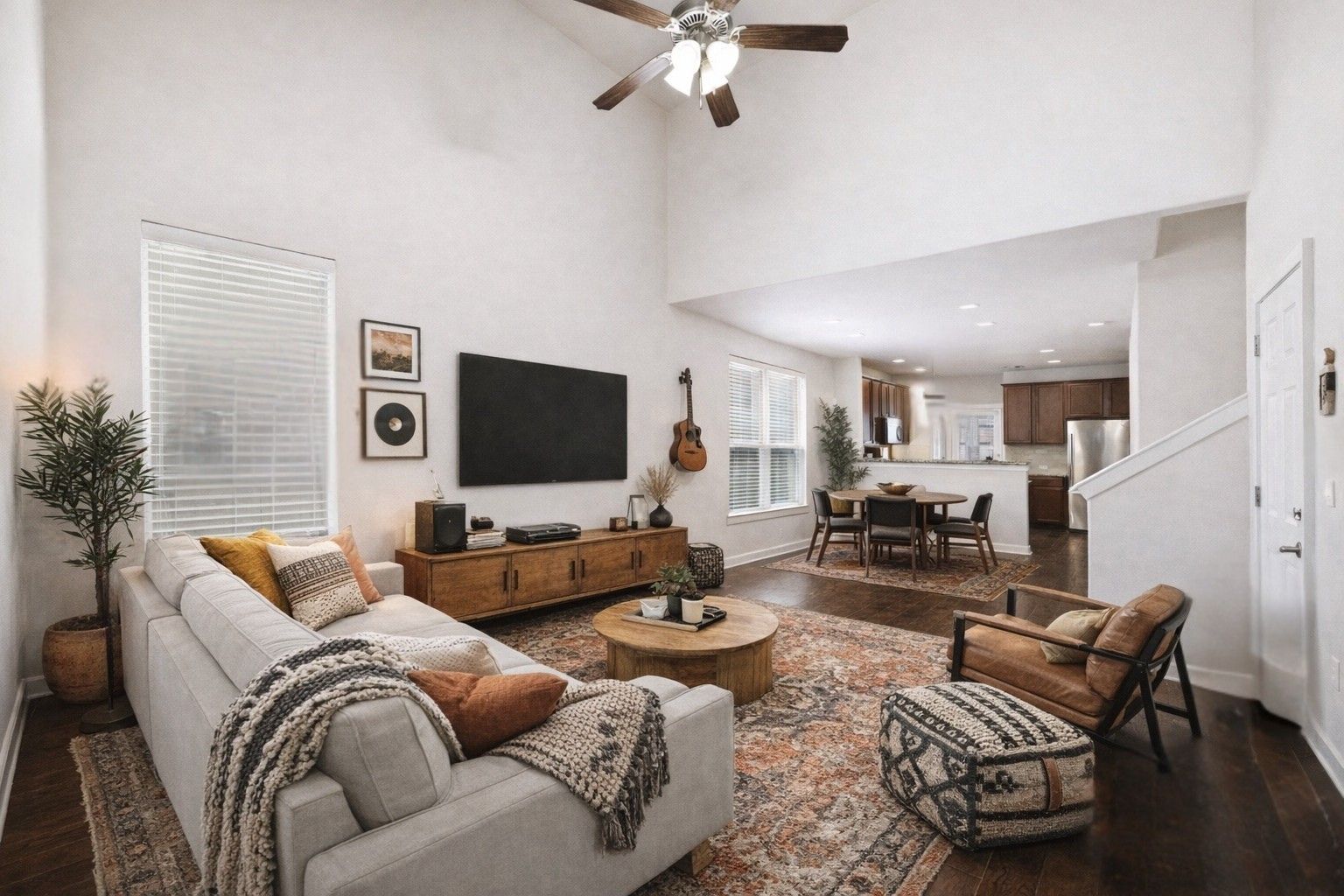 Virtually staged Living Area. High ceiling and pretty wood floors open to the kitchen.