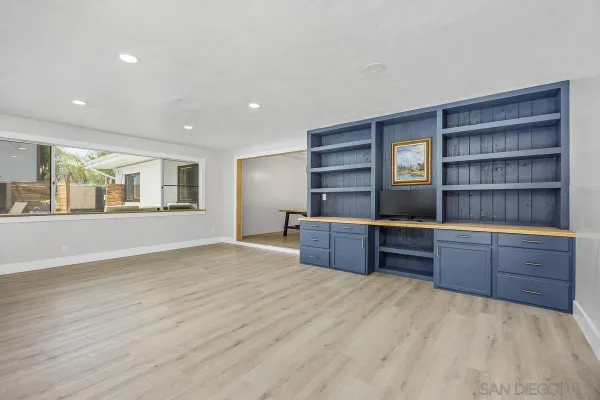 a kitchen with stainless steel appliances kitchen island granite countertop a stove a sink and a refrigerator with wooden cabinets