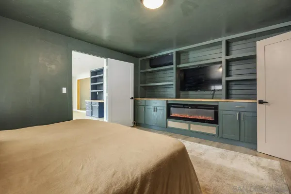 a bedroom with a bed and a television