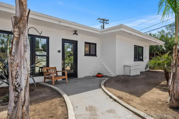 a view of a house with backyard porch and sitting area