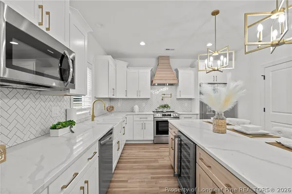 a kitchen with a sink stove and microwave