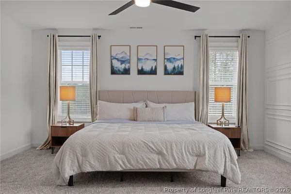 a bedroom with a large bed and a window