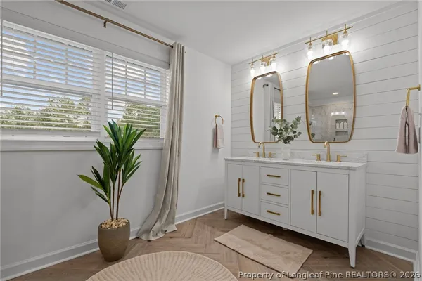 a bathroom with a potted plant and a sink