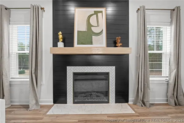 a living room with a fireplace and a rug