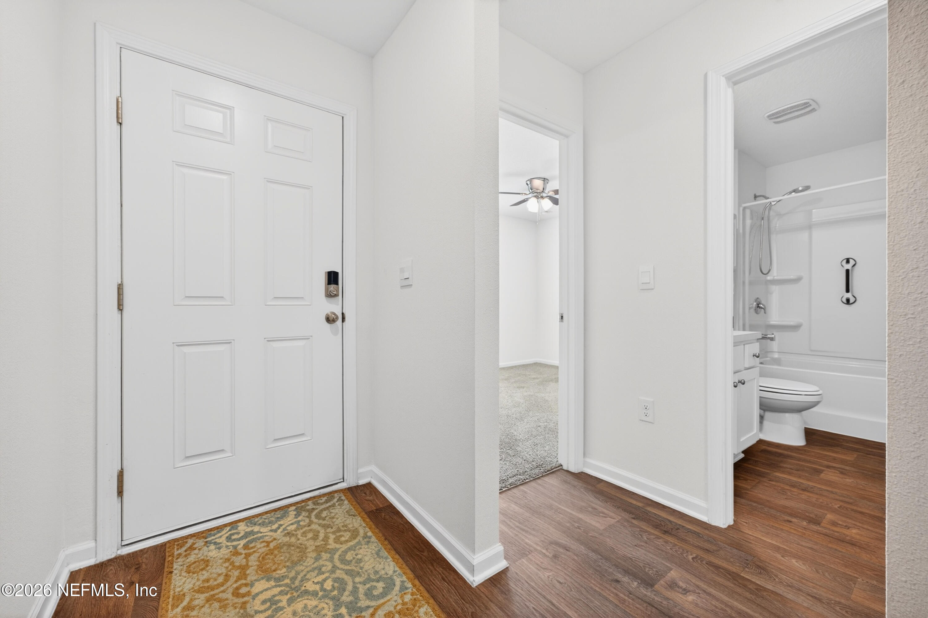 231 Encanto Way Street St. Augustine, FL 32084 - Photo 4 of 36 an empty room with wooden floor and a bathroom