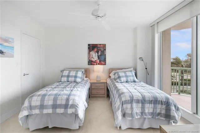 a room with a large window and bed