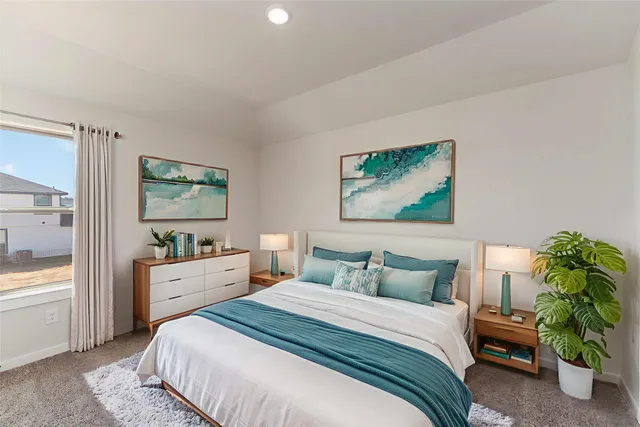 a bedroom with a bed and a potted plant