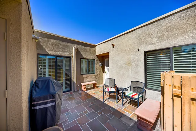 a view of a patio with table and chairs and wooden floor