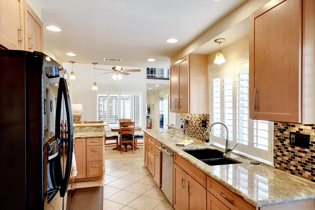 a large kitchen with a large window and stainless steel appliances