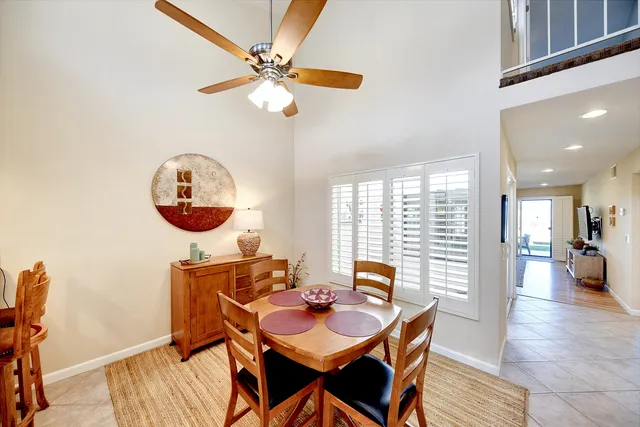 a view of a dining room with furniture and chandelier