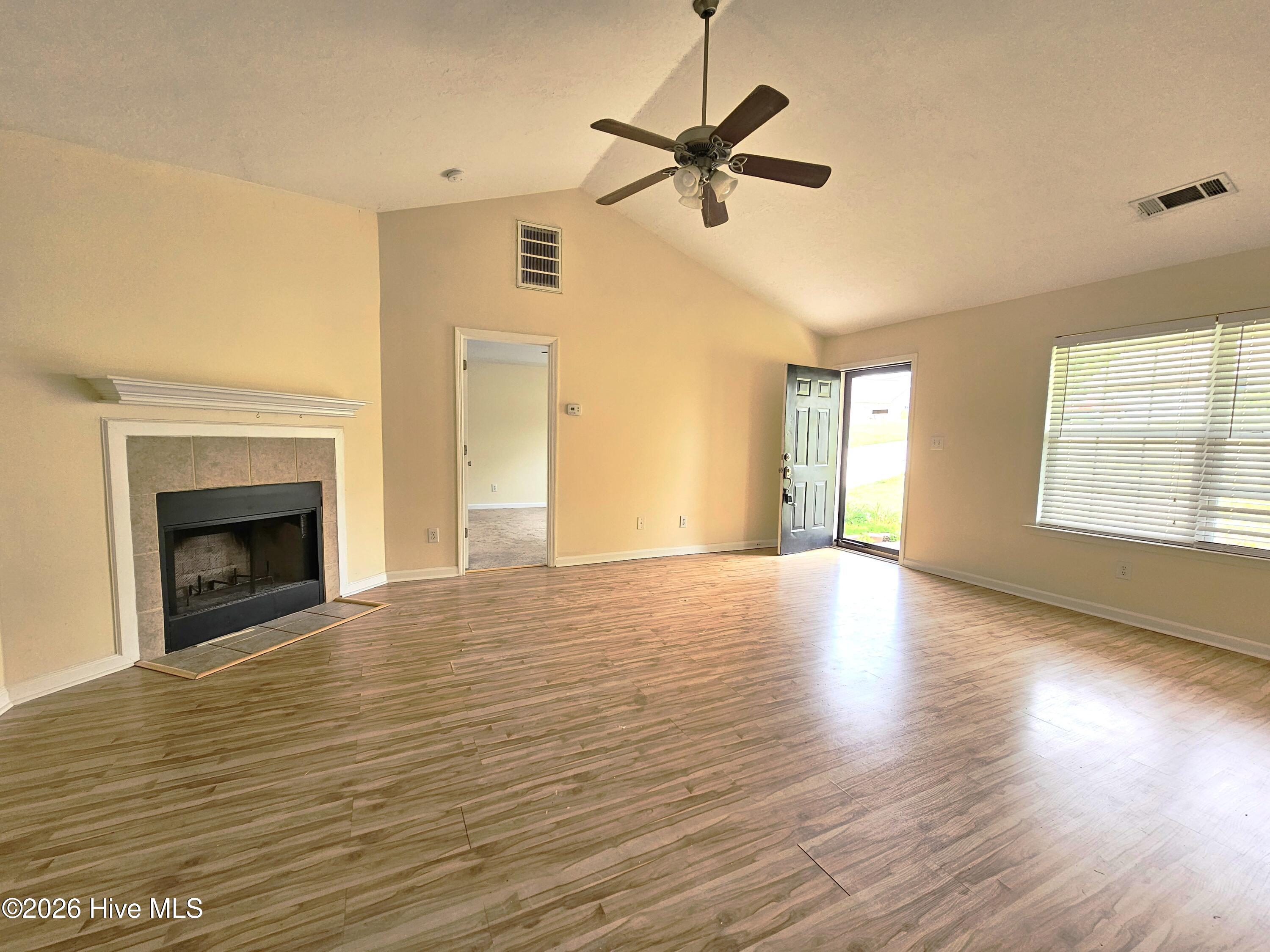 206 Corley Circle Grovetown, GA 30813 - Photo 2 of 12 Great Room - fireplace, vaulted ceiling, ceiling fan and laminate flooring.