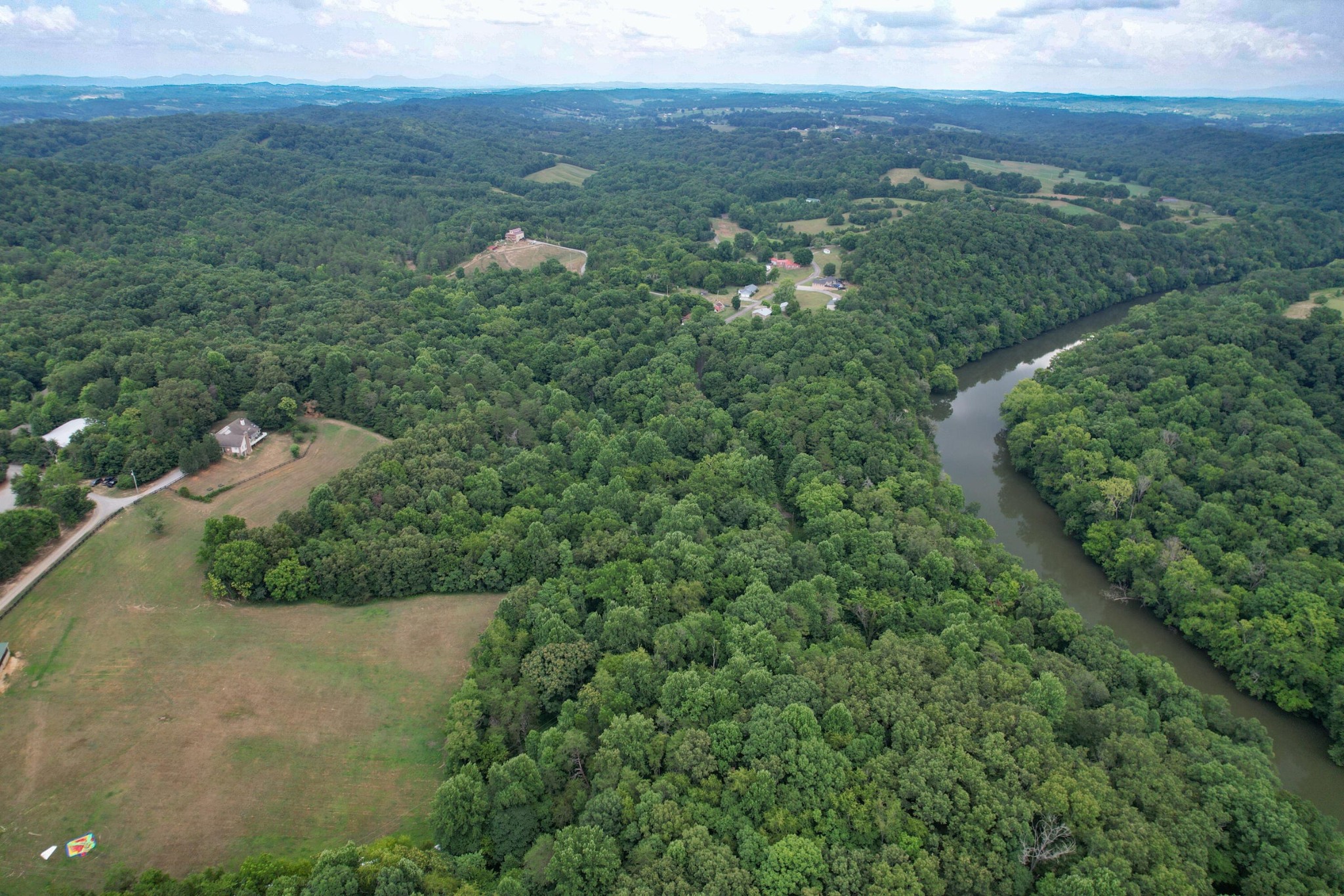 1 Pates Hill Road Mosheim, TN 37818 - Photo 15 of 22 an aerial view of green landscape with trees houses and mountain view
