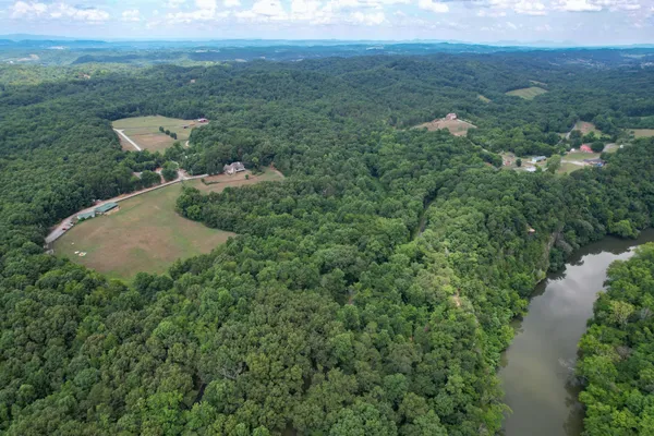 an aerial view of a house with a yard and lake view