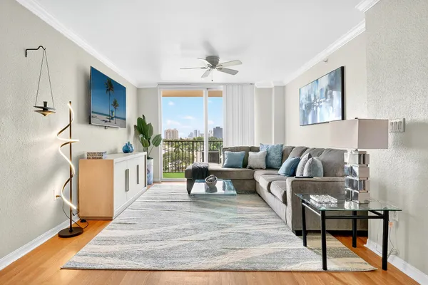 a living room with furniture and a wooden floor