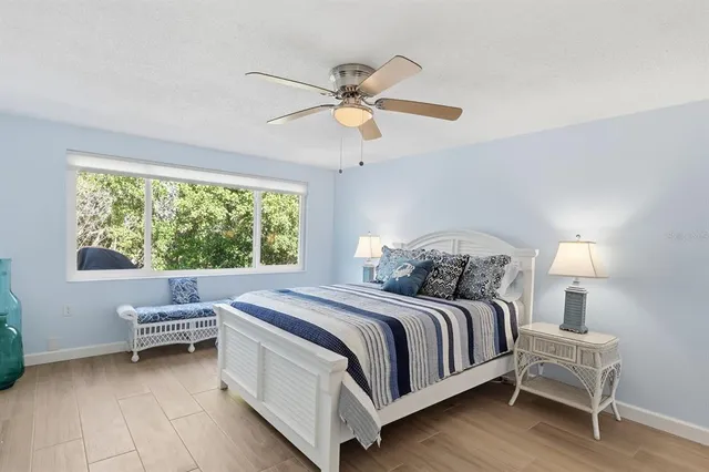 a bedroom with a large bed and a chandelier