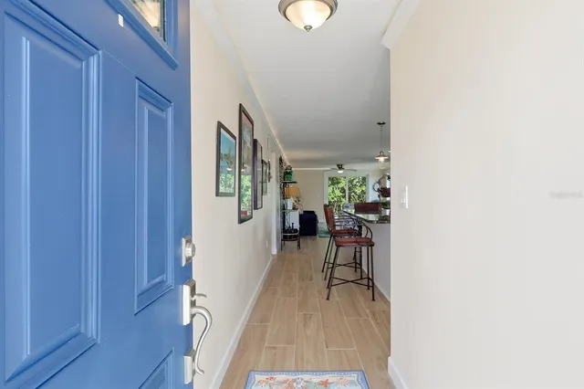a hallway with a dining table and chairs