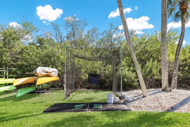 a swimming pool with outdoor seating and yard