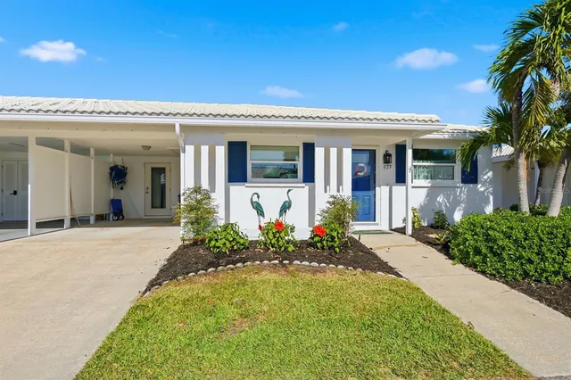 a view of a house with a yard and plants